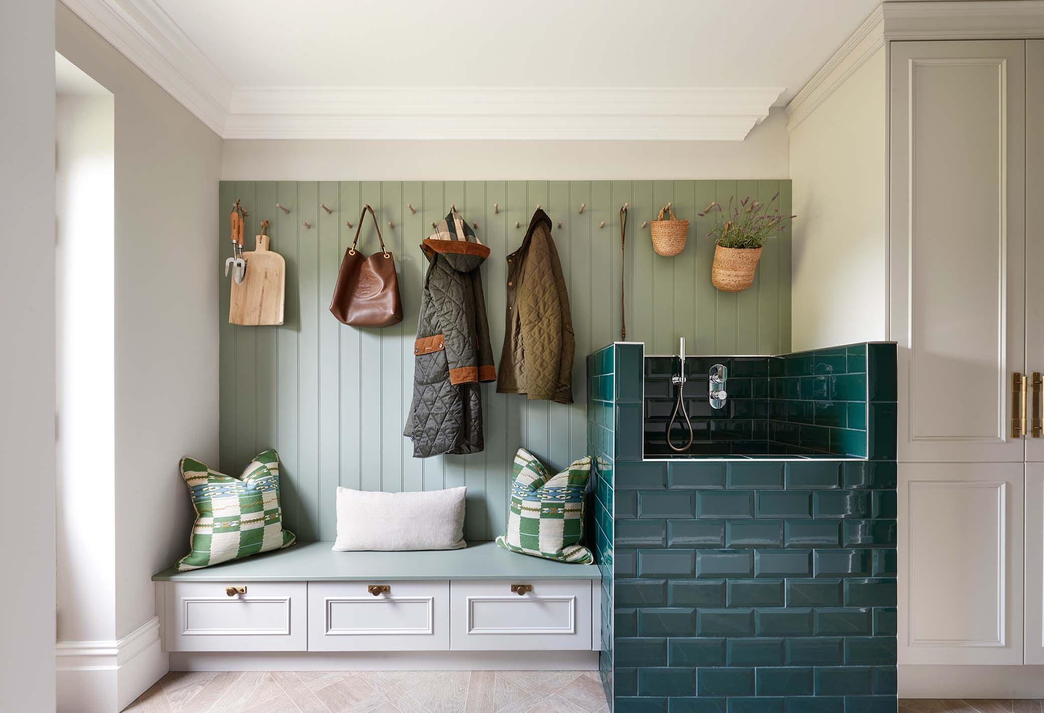 bespoke utility space with a green tiled dog wash area in a surrey home