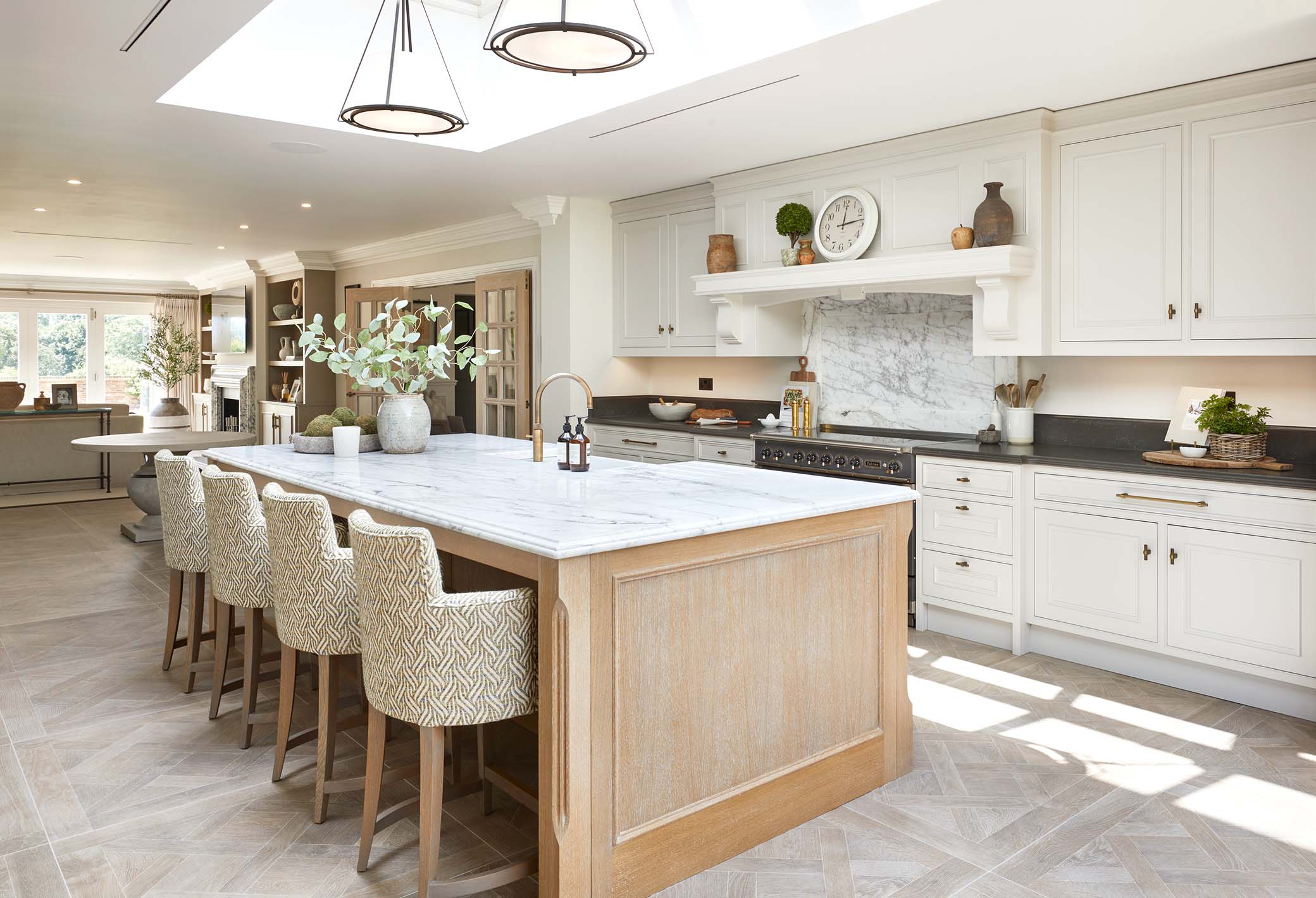 luxury kitchen island and range cooker with lounge in the background