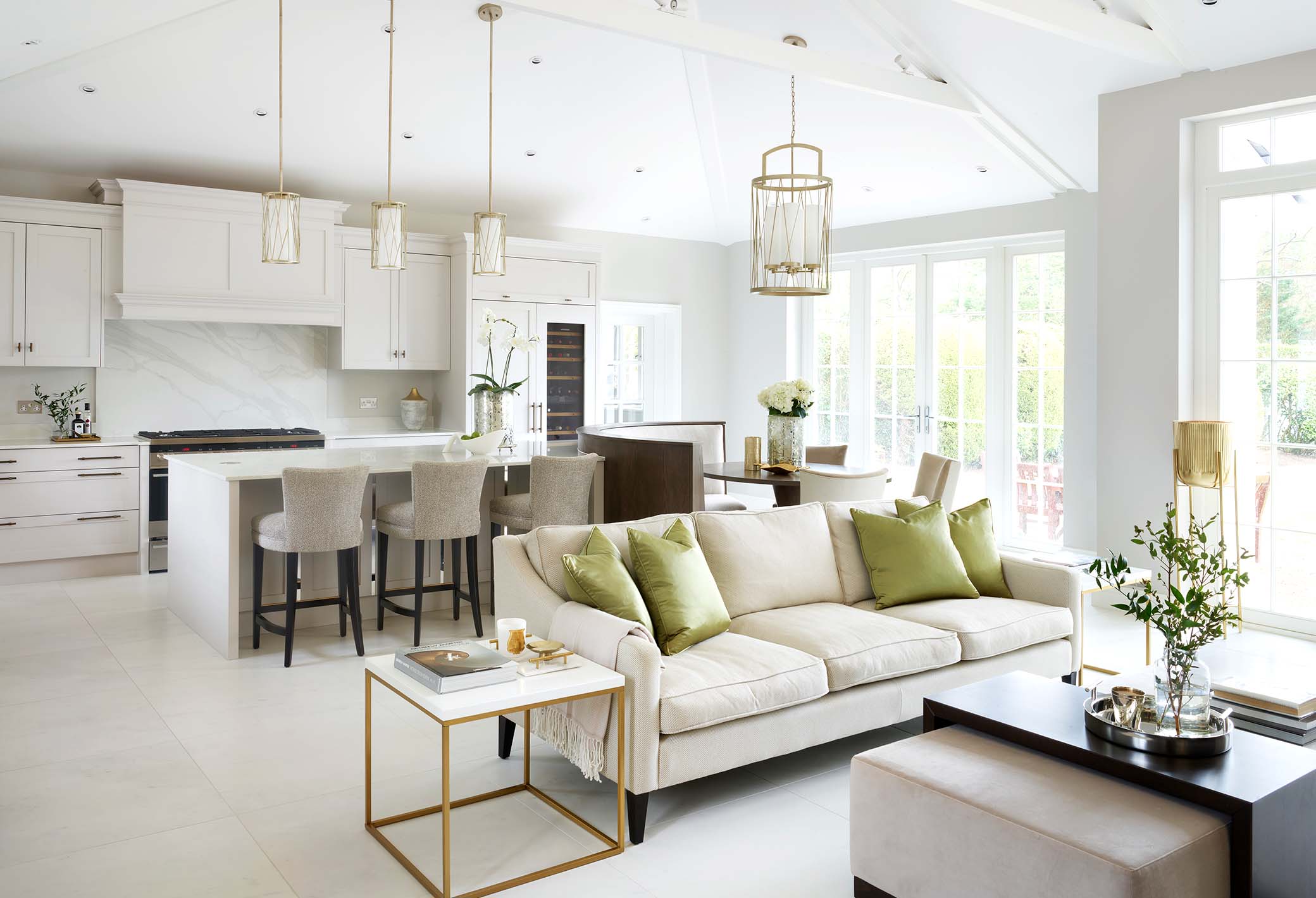 luxury kitchen and living space with sofa seating area in the foreground and kitchen behind