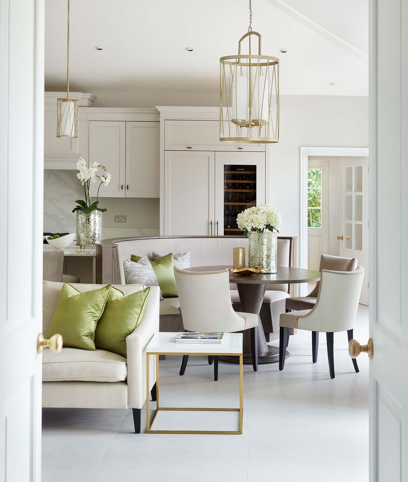 Charles Yorke Perthshire Scotland Bespoke Kitchen Seating Area open doors looking through to a sofa and curved kitchen dining seating space