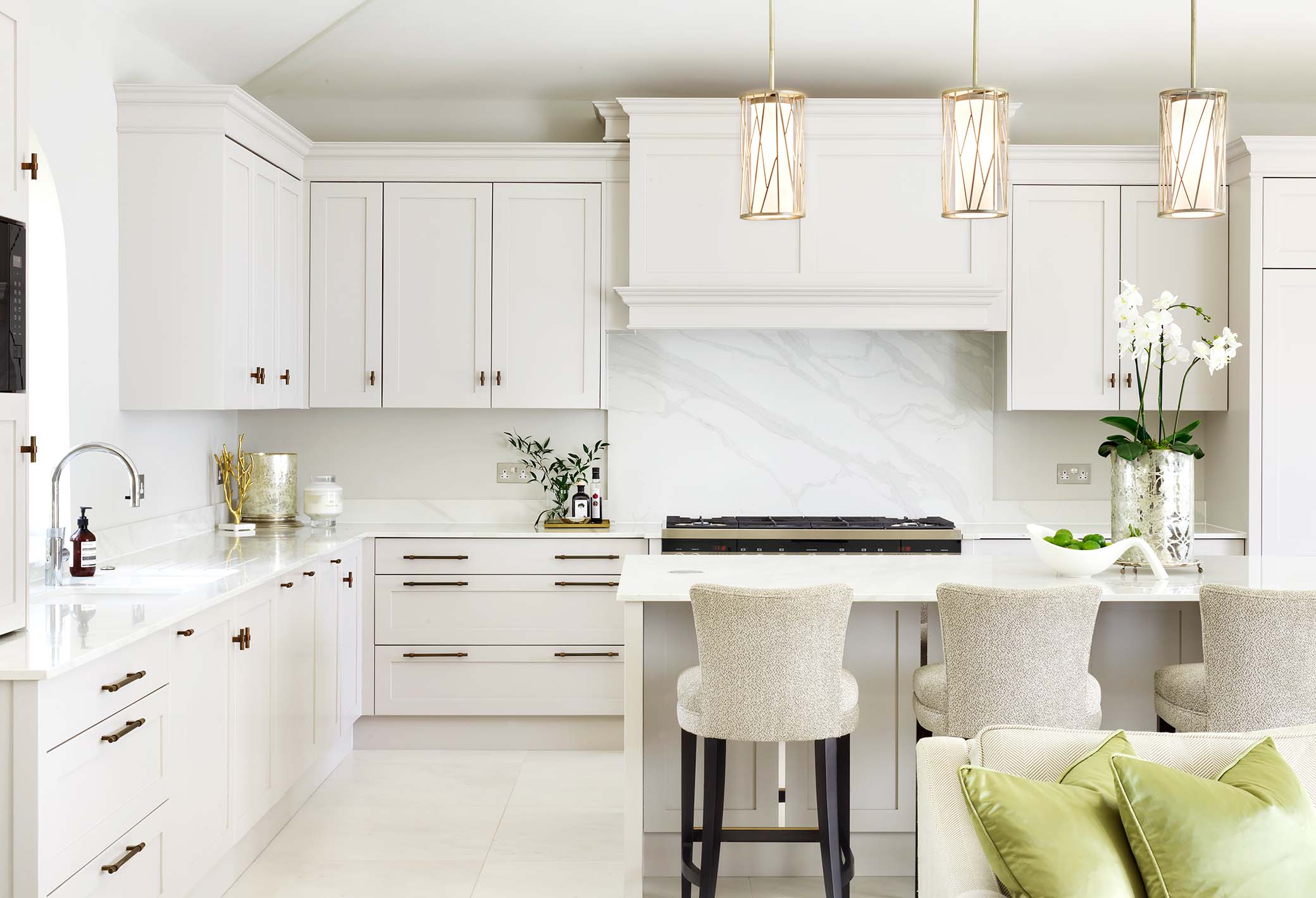 bespoke kitchen with floor and wall cabinetry and kitchen island with custom high seating