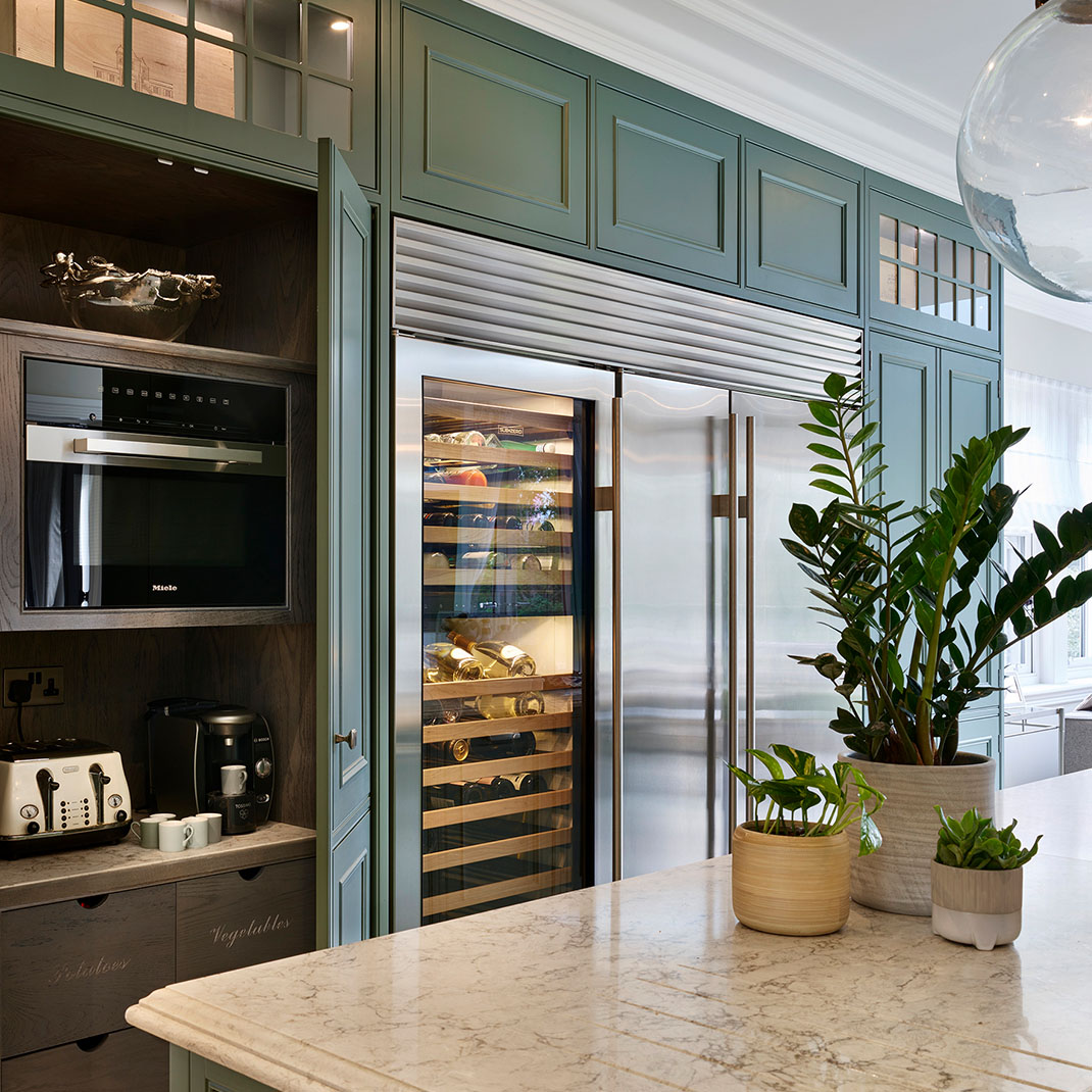 Sage Green Englemere Framed Kitchen Pantry Sage green Englemere Framed kitchen by Charles Yorke, featuring a built-in pantry cupboard and stainless steel wine fridge.